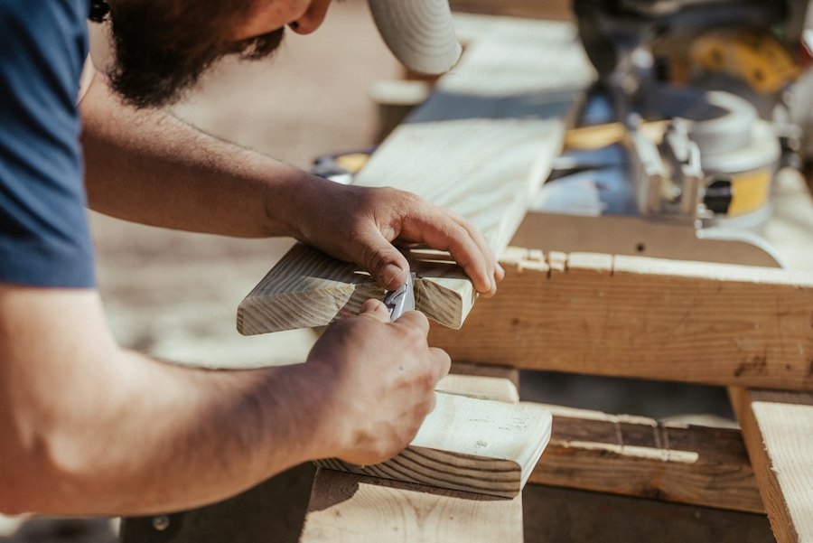 Hands fixing a timber panel in place